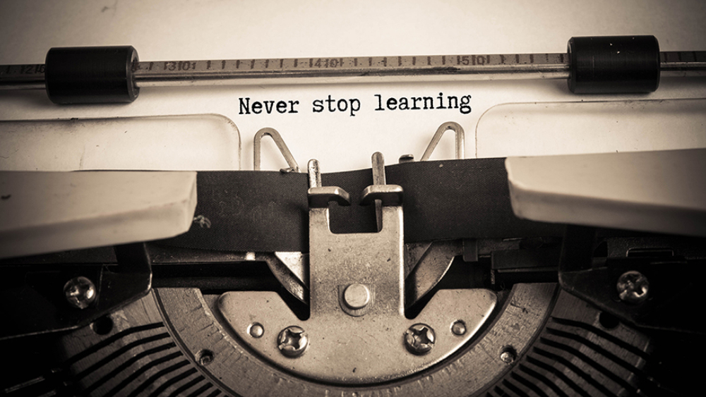 Never stop learning concept on paper with typewriter